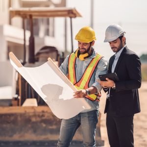 civil-engineer-construction-worker-manager-holding-digital-tablet-blueprints-talking-planing-about-construction-site-cooperation-teamwork-concept Civil engineer and construction worker manager holding digital tablet and blueprints , talking and planing about construction site. Cooperation teamwork concept.